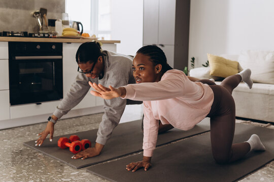 Two black women doing home workout together - Powered by Adobe