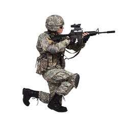 Soldier kneels and aims a rifle