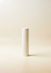 Minimalist aesthetic composition with cylindrical object on plain backdrop