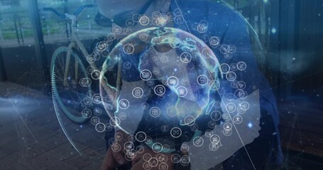 Sitting man wearing glasses blazer holding smartphone on bench outside, bicycle and network globe