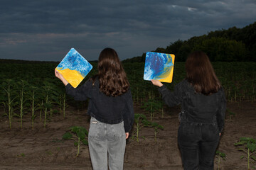 A two young attractive women against stormy sky in the evening	