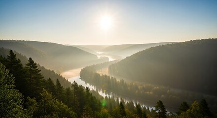 Stunning aerial view of a winding river flowing through a misty, forested valley. Golden sun rays pierce through the morning fog, creating a tranquil and beautiful nature landscape scene.