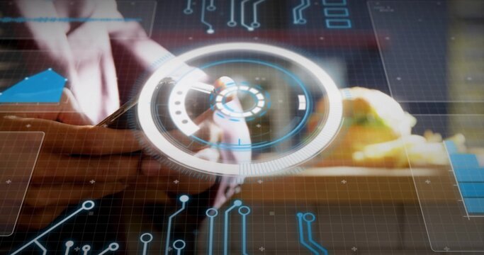 Designer manipulating circular hologram at wooden desk, with stylus and circuit graphics