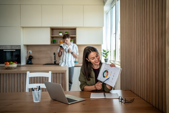 Businesswoman working from home having video call using charts - Powered by Adobe