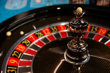 Obraz premium Roulette Wheel Close-up Casino Game with Ball and Numbers