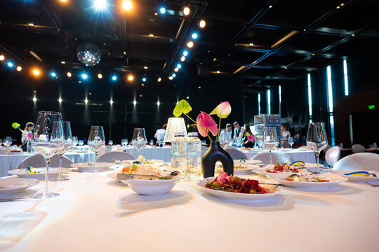 Banquet table served with glasses, food and elegant decoration for wedding or corporate event