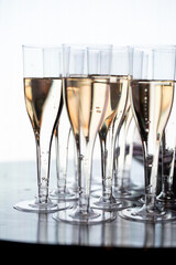 Close-up of champagne glasses filled with sparkling wine, elegant celebration table setting for festive party, wedding, New Year or luxury corporate event