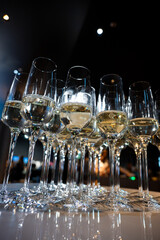 Close-up of champagne glasses filled with sparkling wine, elegant celebration table setting for festive party, wedding, New Year or luxury corporate event