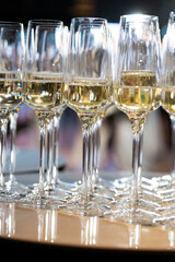 Close-up of champagne glasses filled with sparkling wine, elegant celebration table setting for festive party, wedding, New Year or luxury corporate event