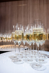Close-up of champagne glasses filled with sparkling wine, elegant celebration table setting for festive party, wedding, New Year or luxury corporate event