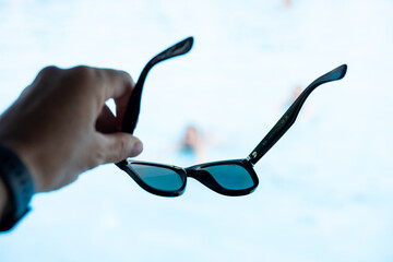 Sunglasses placed on table outdoors, summer fashion accessory close-up
