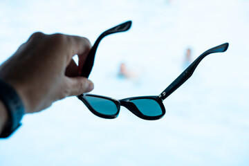 Sunglasses placed on table outdoors, summer fashion accessory close-up