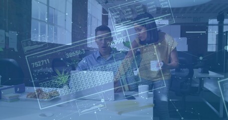 Reacting coworker noticing data overlay on laptop while colleague holding coffee mug in office