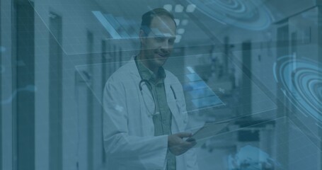 Reviewing holographic data overlays, doctor using tablet in hospital corridor, with stethoscope