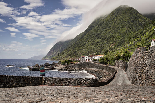 Panoramic view of Faj&atilde; de S&atilde;o Jo&atilde;o village with mountain backdrop, S&atilde;o Jorge Azores