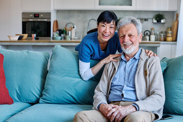 Doctor or nurse caregiver with senior man talking and having fun at home or nursing home