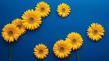 Vibrant yellow gerbera daisies arranged in geometric pattern against deep blue background.