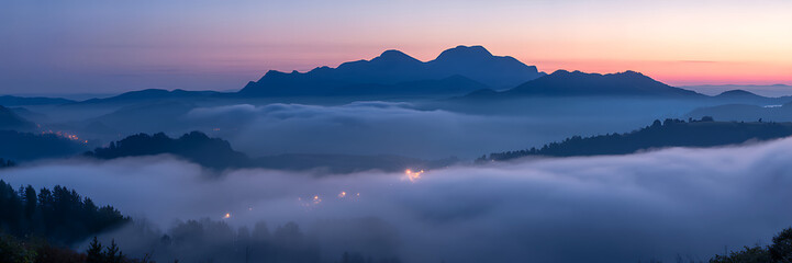 Fototapeta premium Majestic mountain range reflecting in calm water during a serene sunset sky