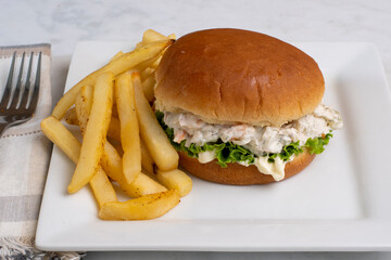 shrimp seafood salad sandwich with fries