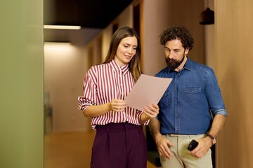 Business Colleagues Discussing a Document Collaboratively in Office Environment