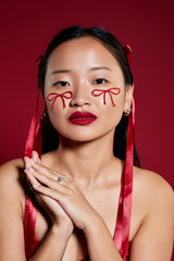 Creative makeup art featuring a beautiful young Asian woman in a studio setting