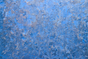 Frost pattern on a frozen window at winter. Natural background, texture