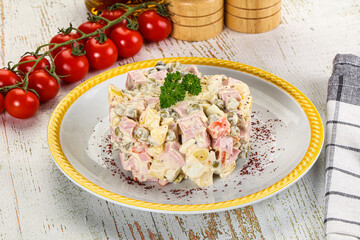 Russian traditional Olivier salad with sausages