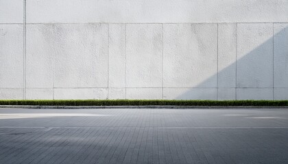 city street with long concrete wall covered in white plaster featuring copy space and mockup