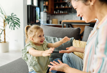 mother and daughter playing and having fun at home