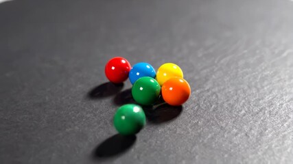 Colored Beads Roll and Cluster on Slate, Playful Overlay Texture