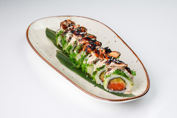 Delicious Japanese fusion sushi roll with salmon, mussels, chuka seaweed, pickled radish