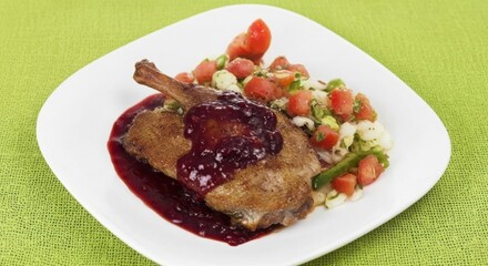 Gourmet duck confit with berry sauce and fresh salad