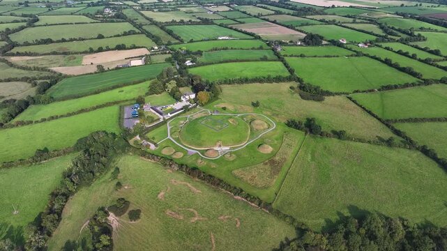 Knowth prehistoric tomb on hill, drone reveal historical site and Irish landscape.