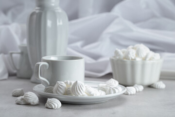 Vanilla meringue and coffee cup on a white marble table.