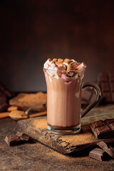 Hot chocolate drink with marshmallows sprinkled with cocoa powder.
