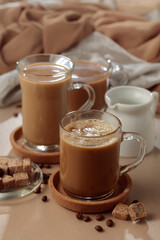 Latte with brown sugar on a beige background.