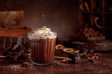 Hot chocolate topped with whipped cream and sprinkled with chocolate chips.
