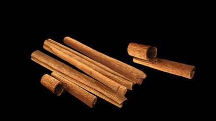 cinnamon sticks isolated on black background.