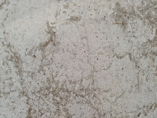 Fototapeta premium Close up of rough concrete wall with stains and weathered texture