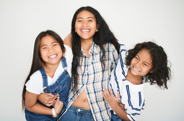teen girl with 9 years thailand twin on studio white background with teen sister