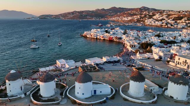 Mykonos aerial view at sunset, traditional Greek windmills on a famous Greek island of Mykonos, holiday in Greece, Cyclades islands, luxury Greek vacation