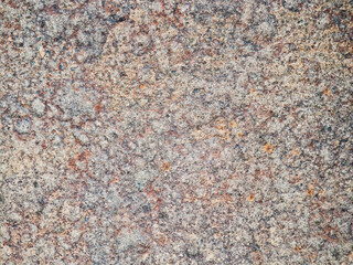 Close up of natural granite stone surface with rough multicolored texture