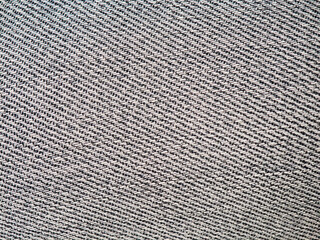Close up of blue grey denim jeans fabric with diagonal woven texture