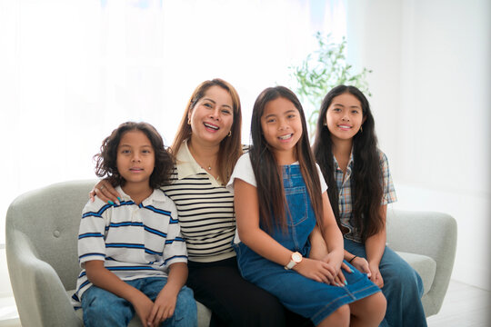 family kid having great time on sofa with his mother - Powered by Adobe