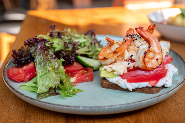 Healthy breakfast. Toast with seafood and vegetable salad