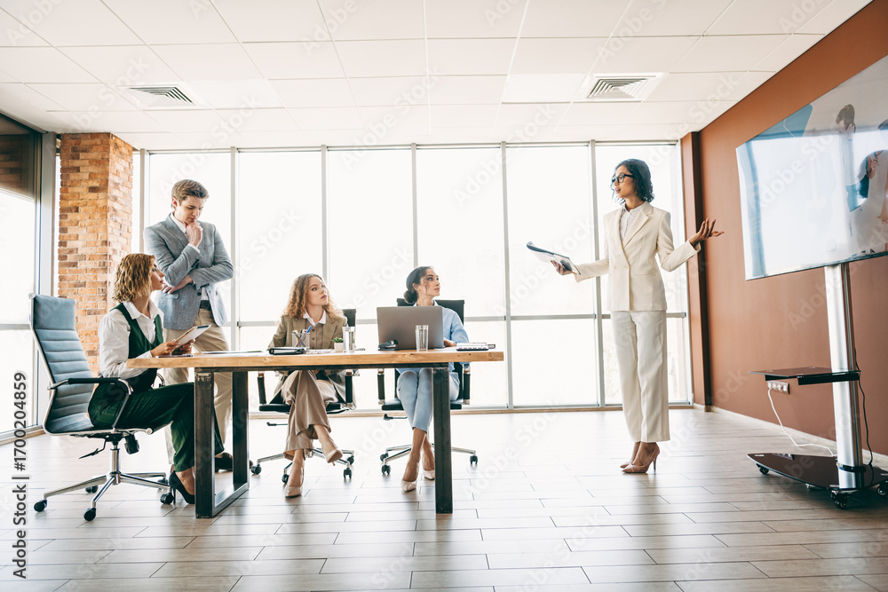 Aufkleber professional team collaborating during a business presentation in a modern office space with large w
