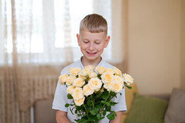 Teenage boy holding beautiful yellow rose bouquet ready to give mother for Mother's Day