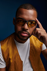 Obraz premium Stylish young man showcases trendy fashion with confidence and poise in a modern setting