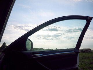 Open Car Door: Sky and Landscape