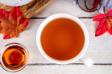 Sweet refreshing Maple hot Tea Drink, tasty aromatic warming beverage with ice cubes and a lot of maple syrup, copy space